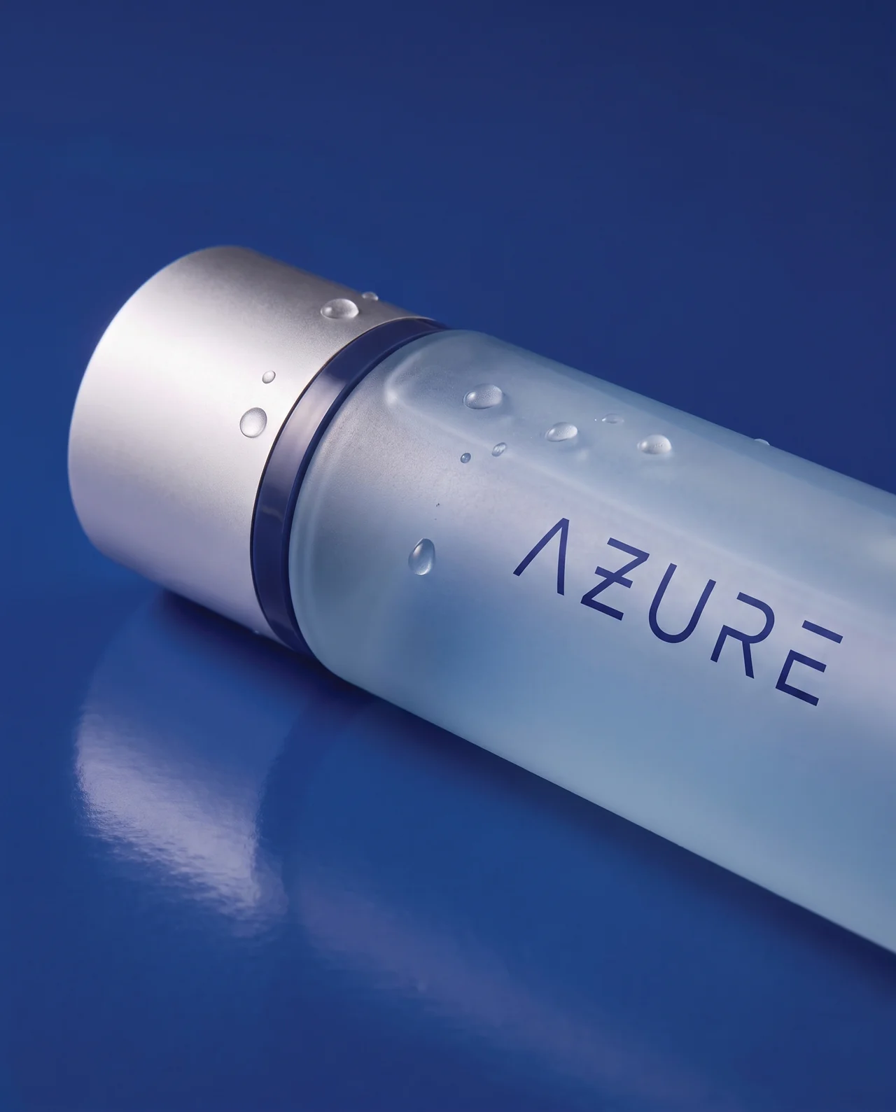 Close-up of the AZURE Scalp Shampoo cap and frosted bottle