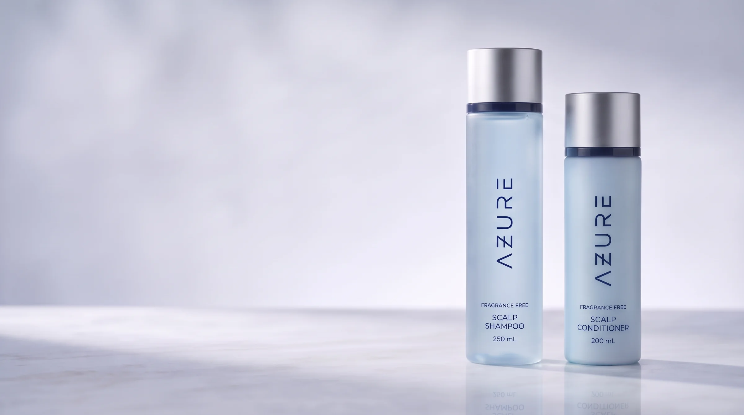 AZURE Scalp Shampoo and Scalp Conditioner bottles standing on pale polished stone in soft daylight