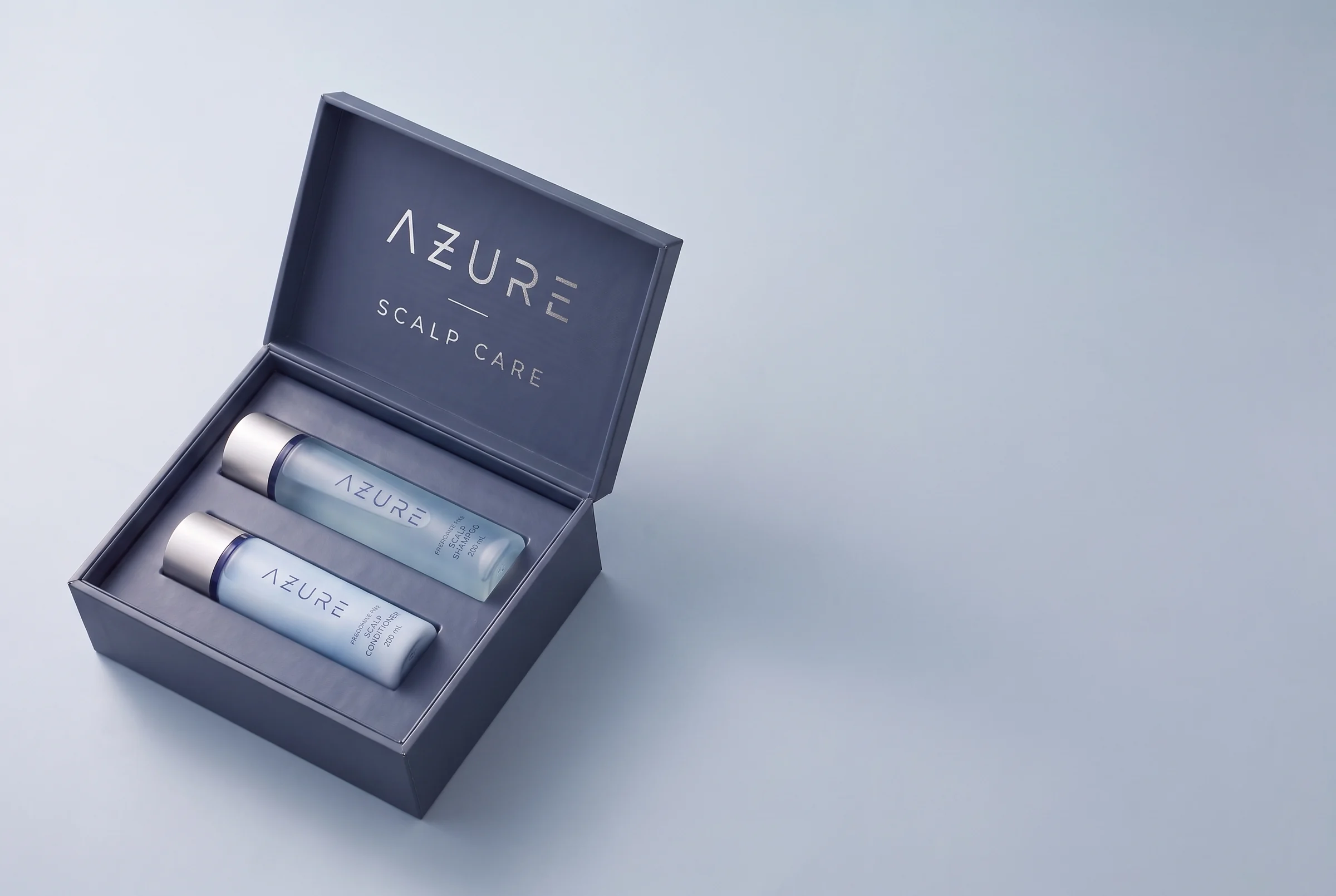 Open AZURE case with the Scalp Shampoo and Scalp Conditioner seated in the fitted interior