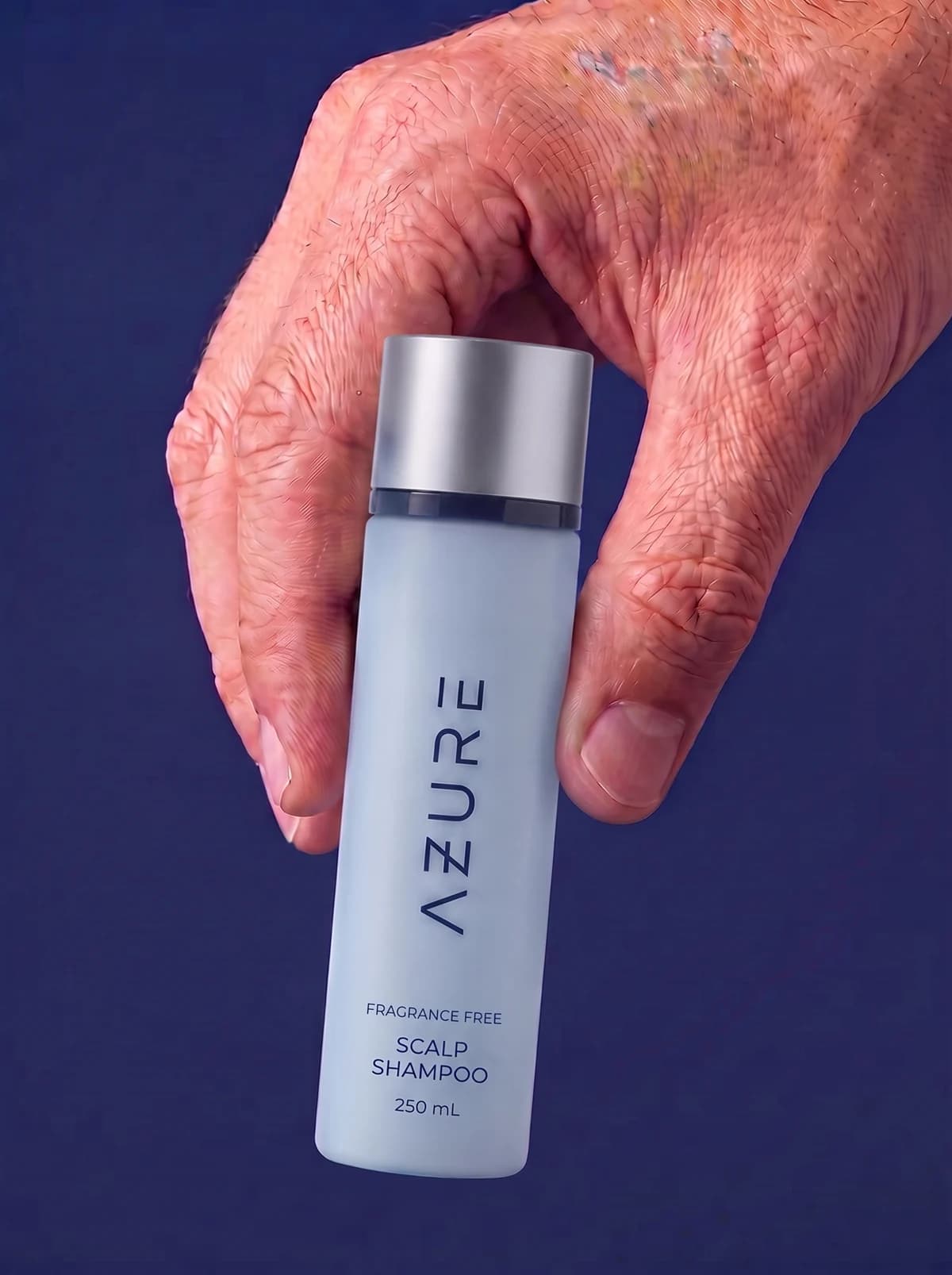 The AZURE Scalp Shampoo held in a hand